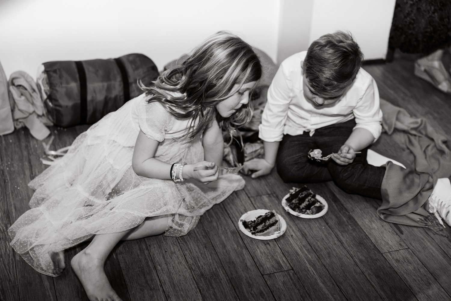 the flower girl and ring bearer eating cake during reception at the 1909 