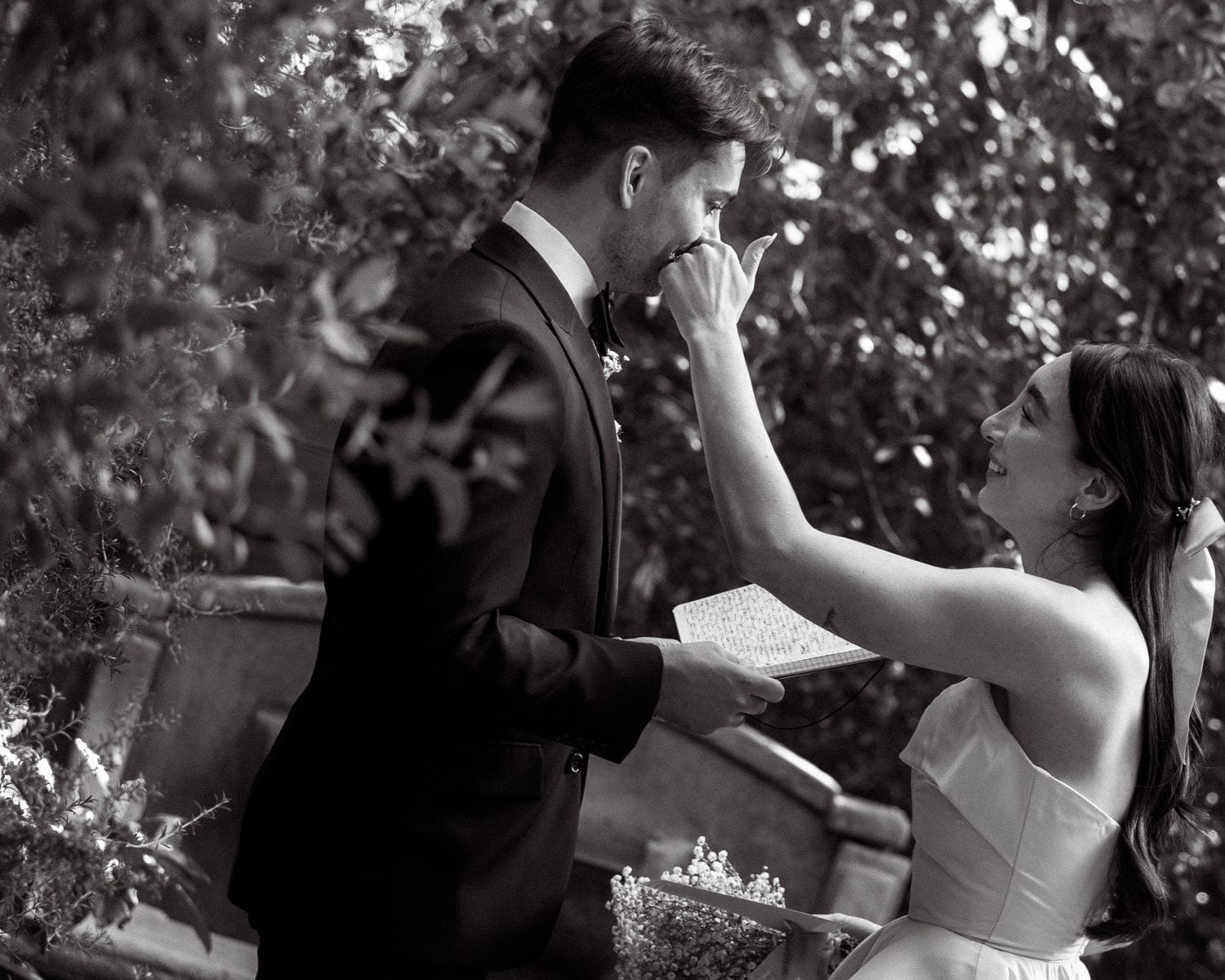 a bride wiping the groom's tears away at the 1909 