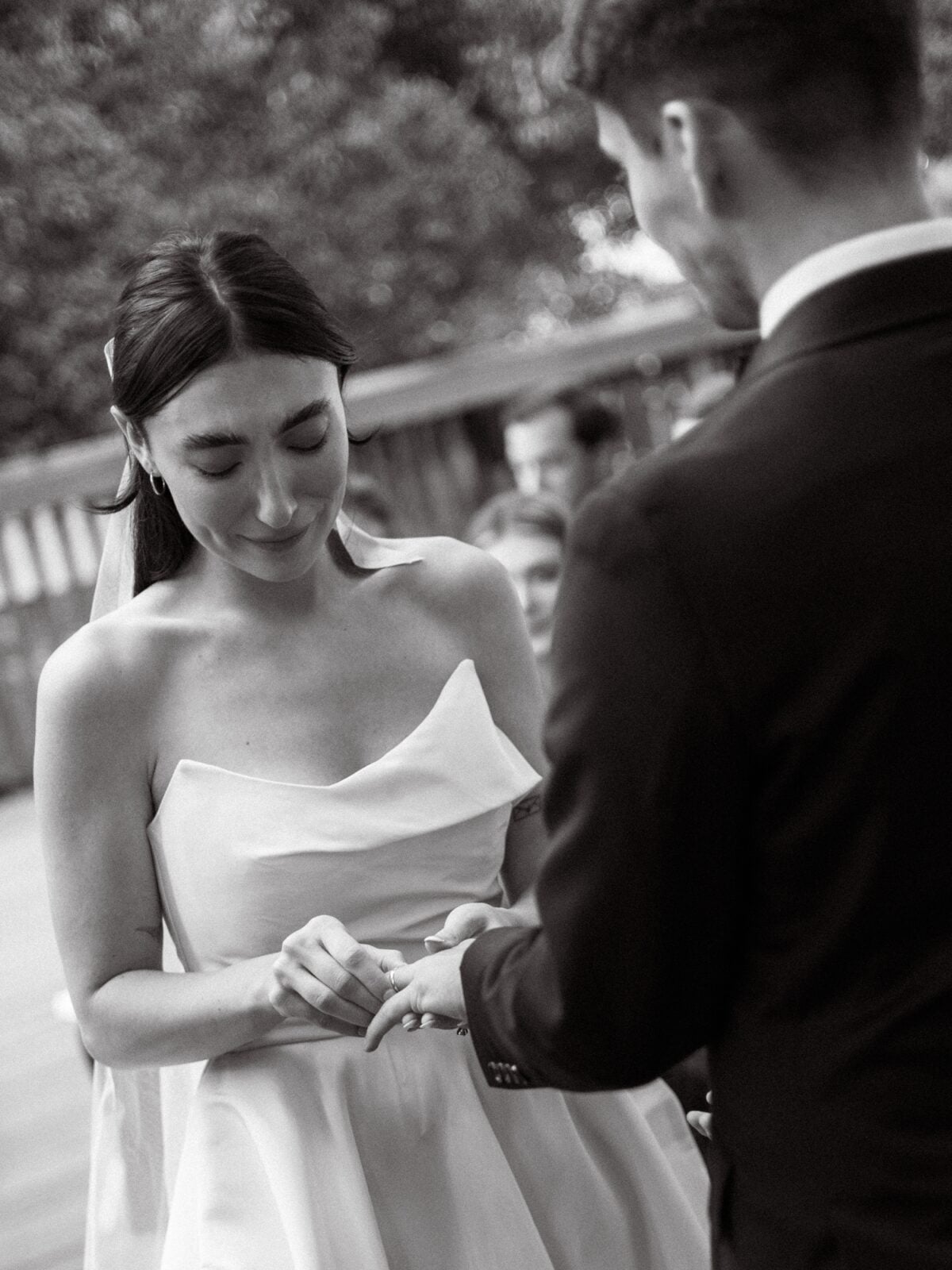 bride putting on the ring on the groom at the 1909 