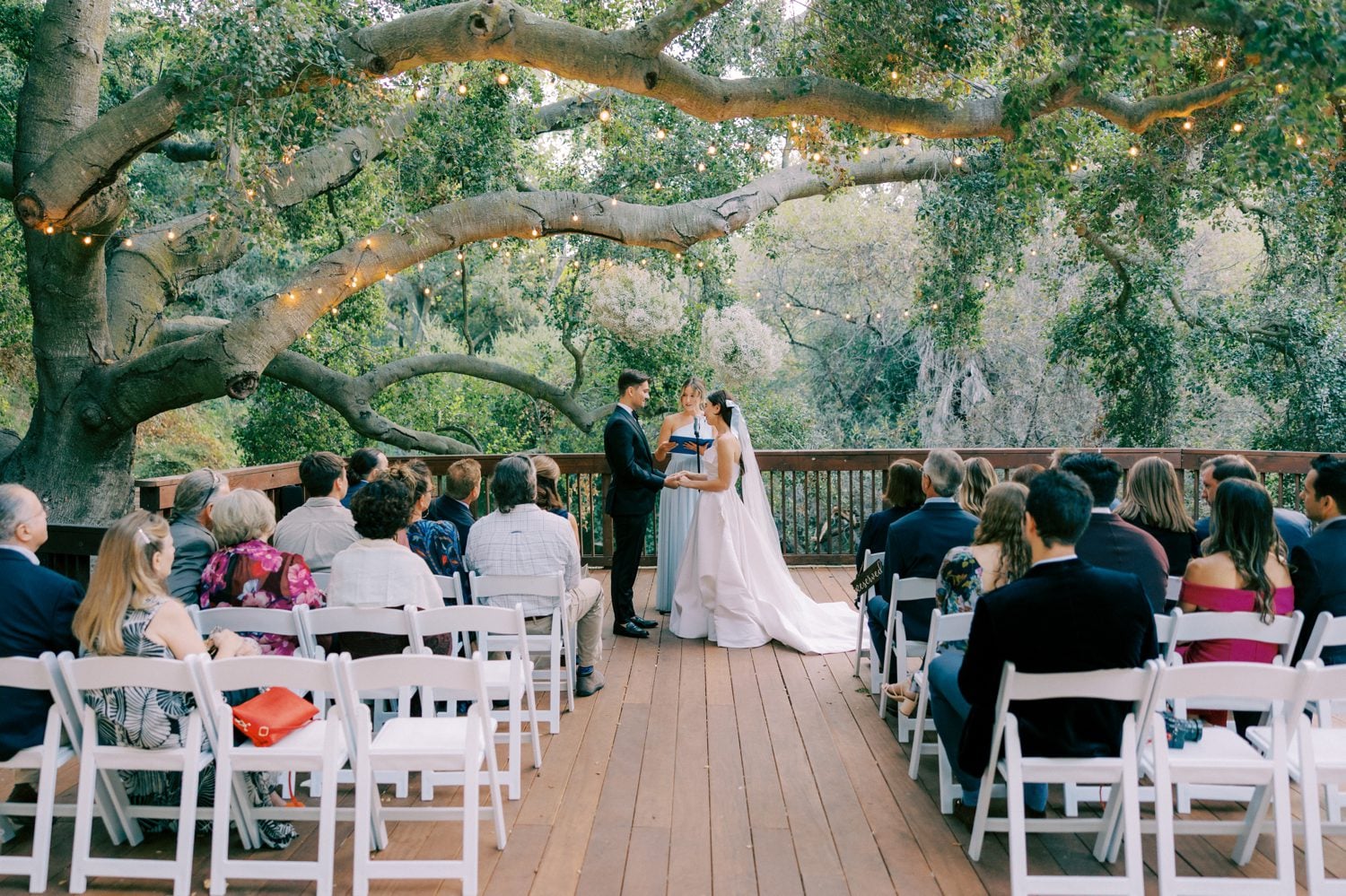 a wedding ceremony at the 1909 under the oak tree in the amphitheater